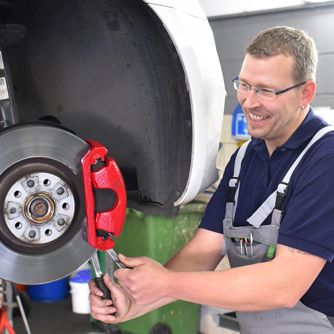 mechanic replacing brake pads