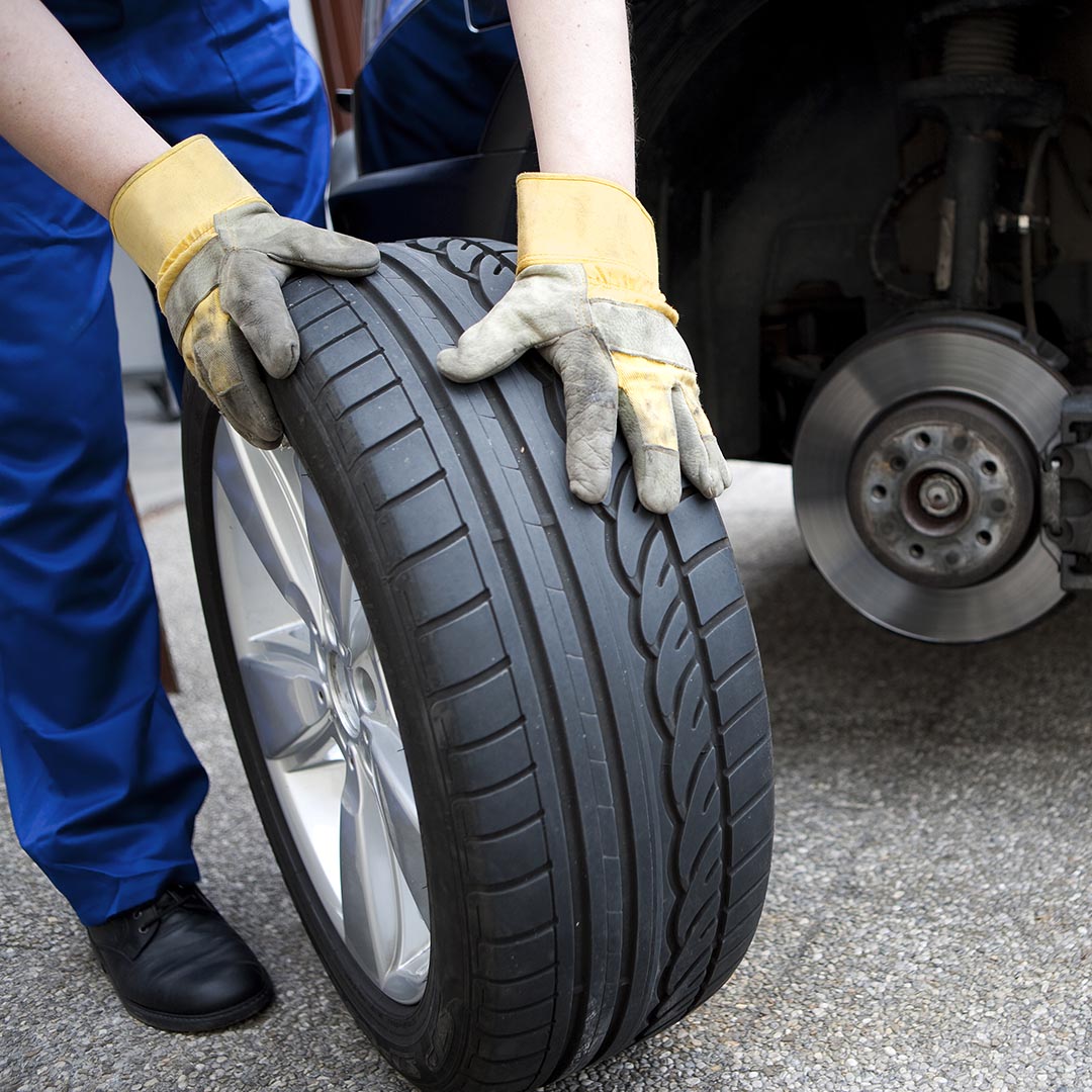 mechanic rotating tires